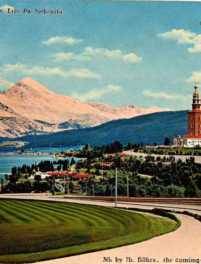 Scenic lakeside view with tower, mountains, and greenery