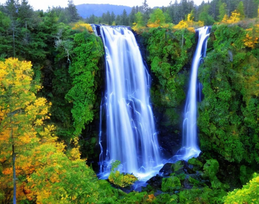 Majestic waterfall in lush greenery with autumn trees