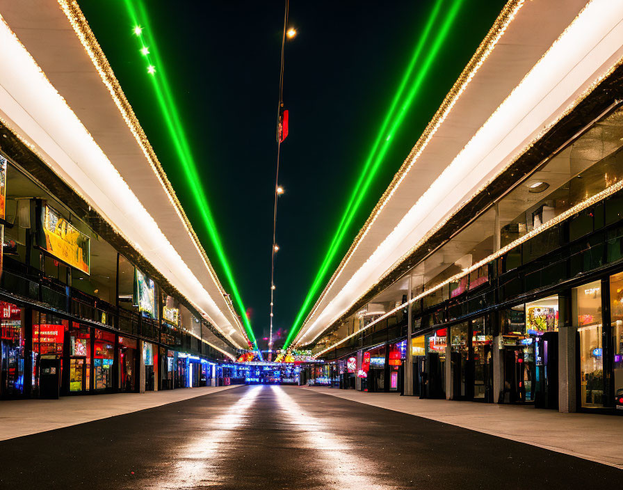 Modern outdoor promenade with bright green neon lights at night