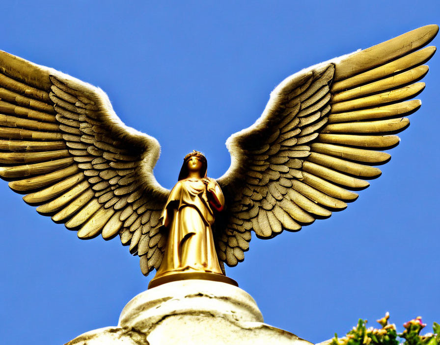 Golden Angel Statue with Outstretched Wings on Clear Blue Sky