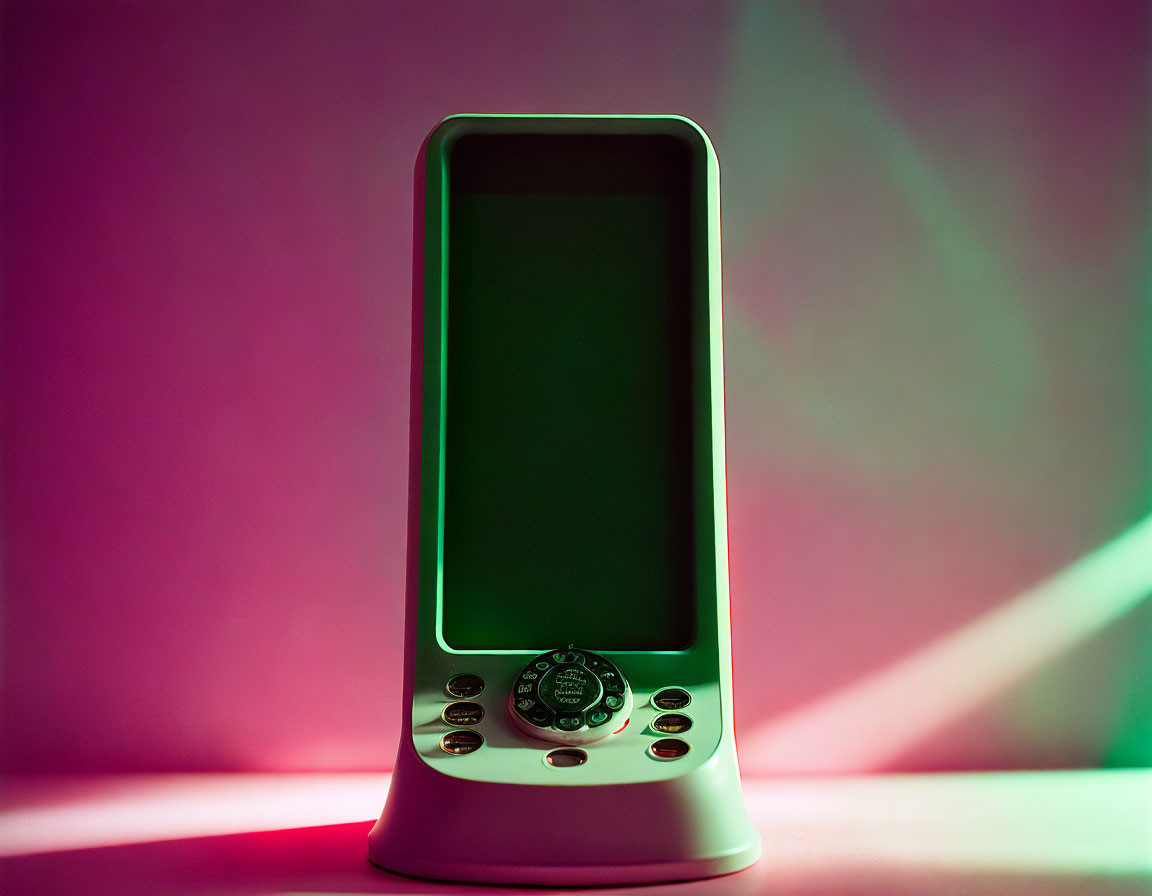 Vintage handheld gaming device on blank screen against pink and green gradient.