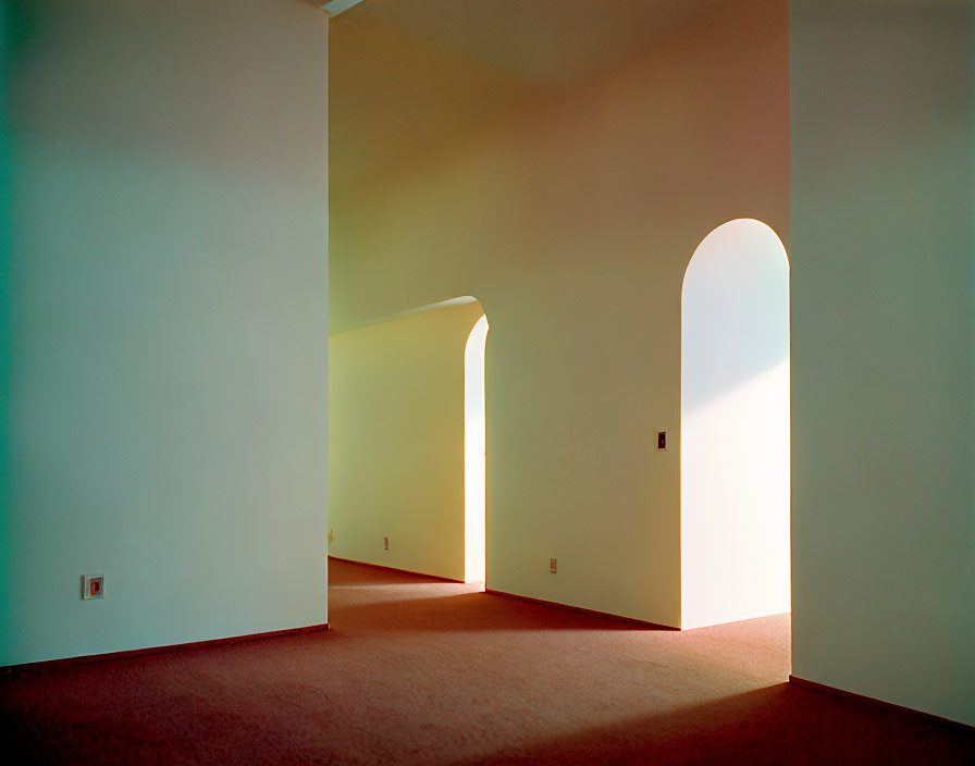 Minimalist Interior with Sunlit White Walls and Arched Doorways