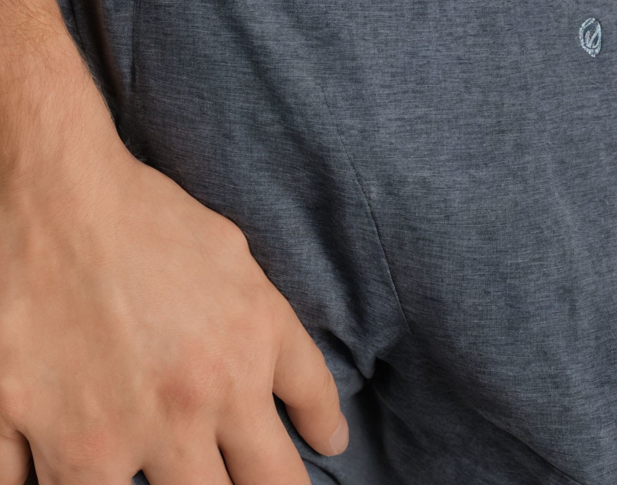 Person in gray textured t-shirt with hand on hip