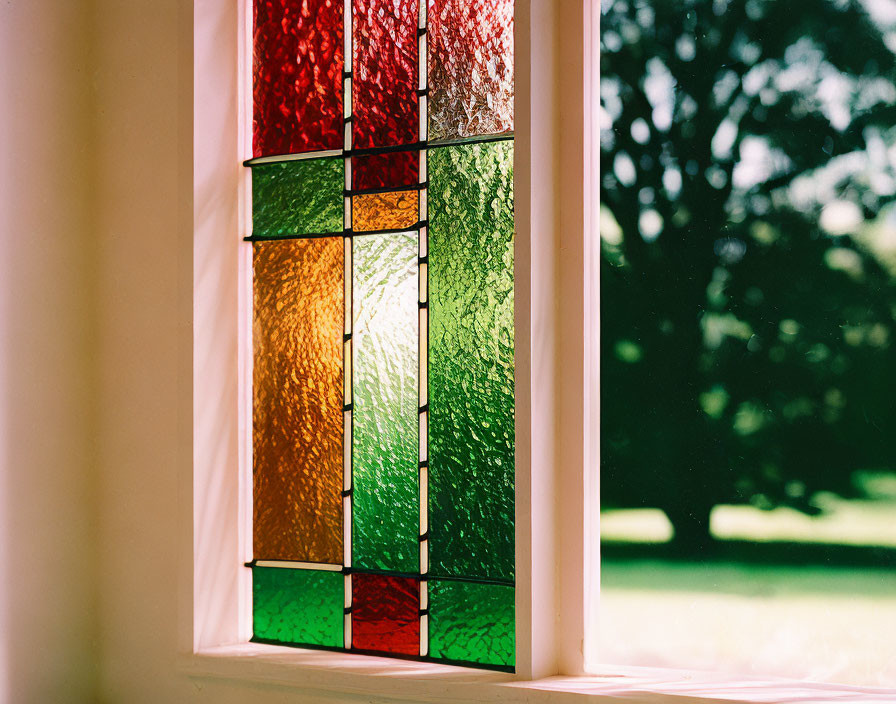 Vibrant stained glass window with red, orange, and green panels