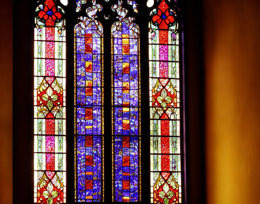 Vibrant Gothic arch stained glass window with intricate patterns