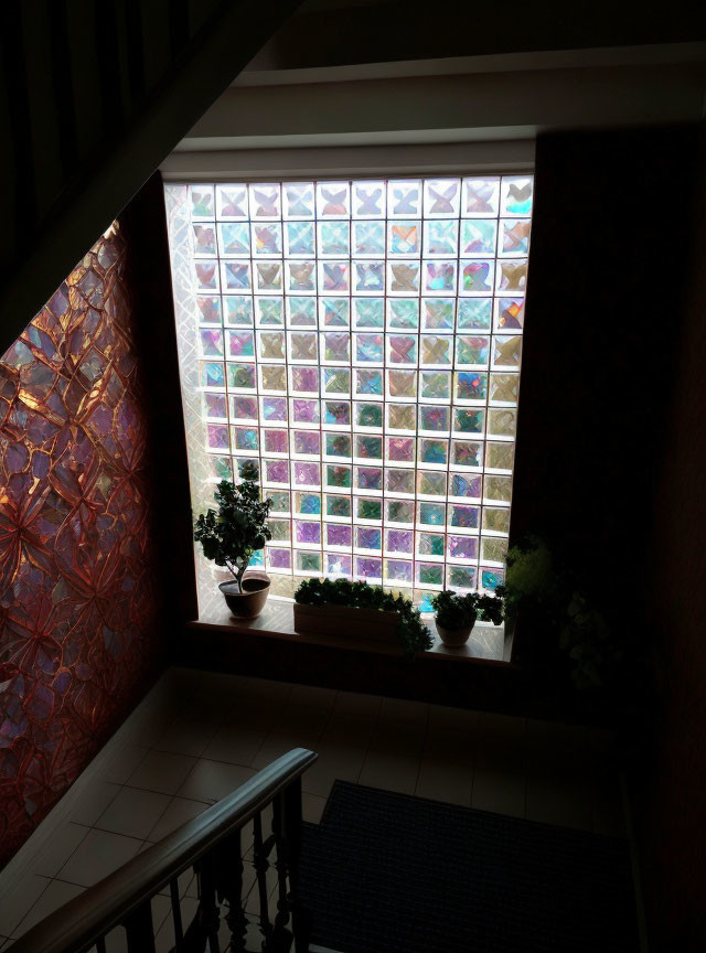 Colorful Glass Block Window in Staircase Landing with Plant & Tile Flooring