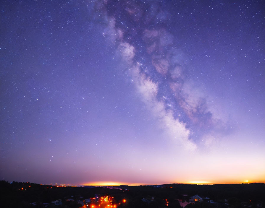 Twilight town silhouette under starry night sky