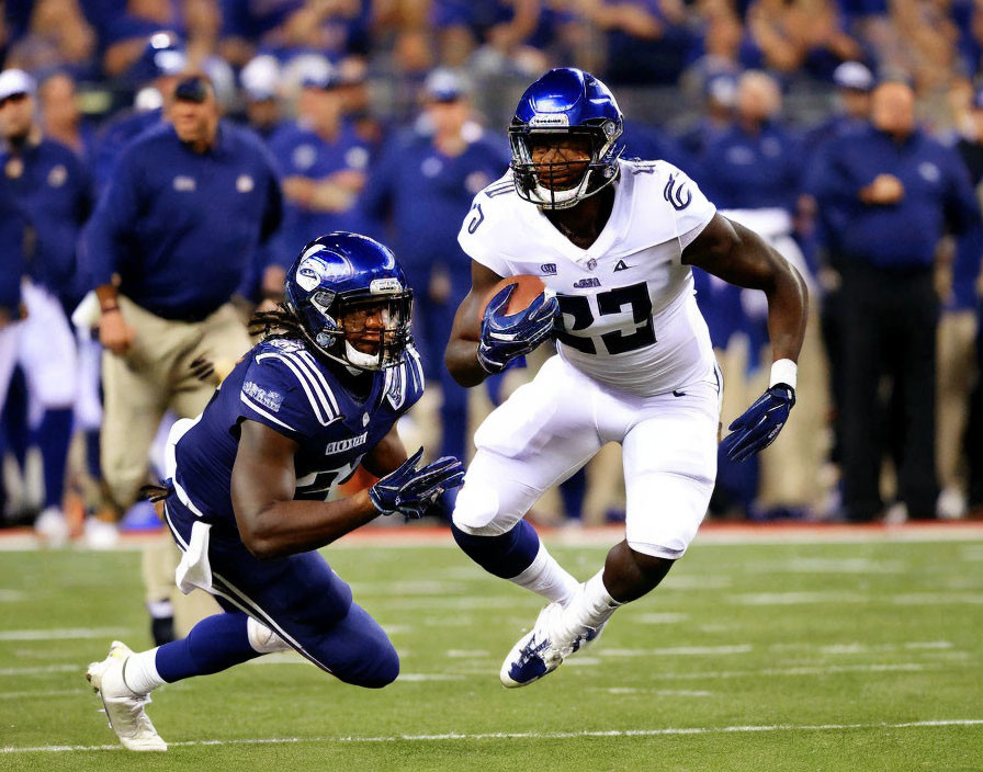 American football players in game action wearing team uniforms and protective gear.