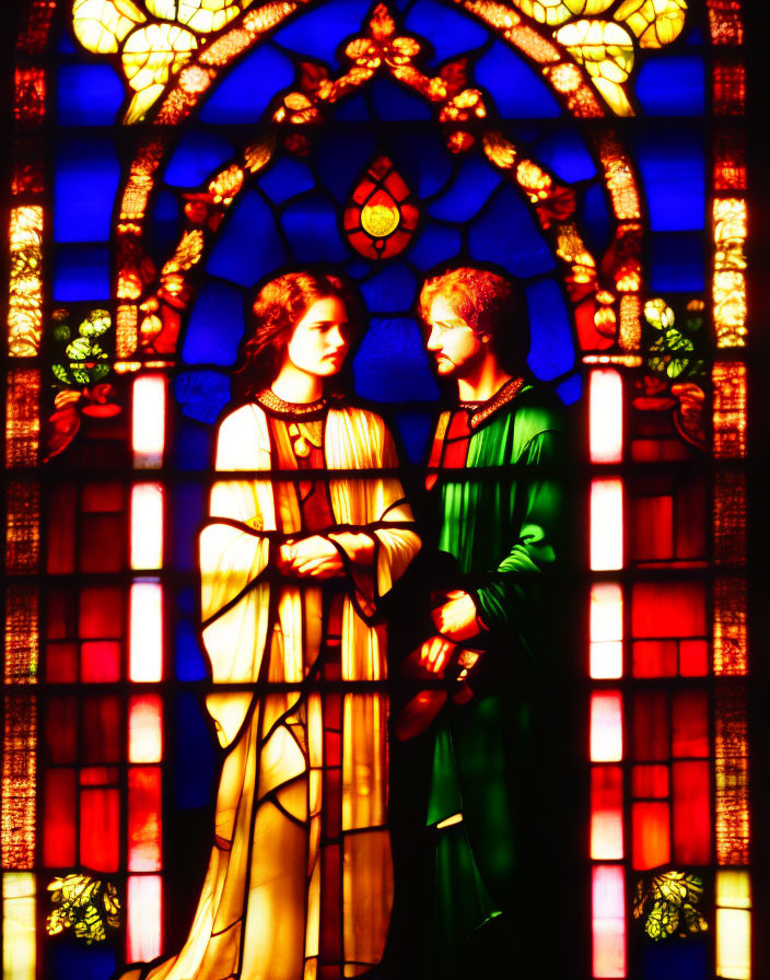 Vivid stained glass window with robed figures on blue and red background