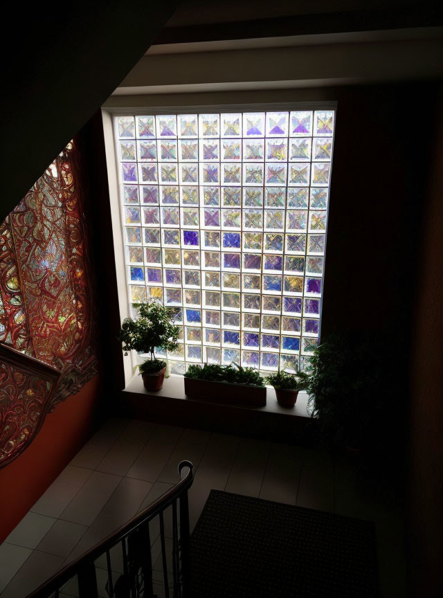 Indoor space with large glass block window, patterned curtain, and potted plants