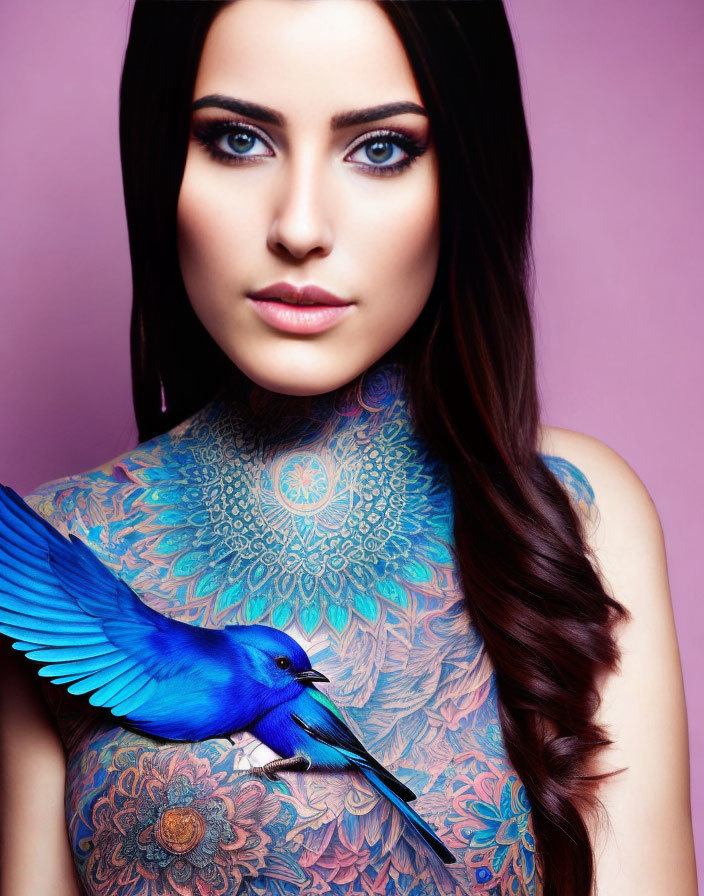 Woman with neck and chest tattoos and blue bird on shoulder against pink background