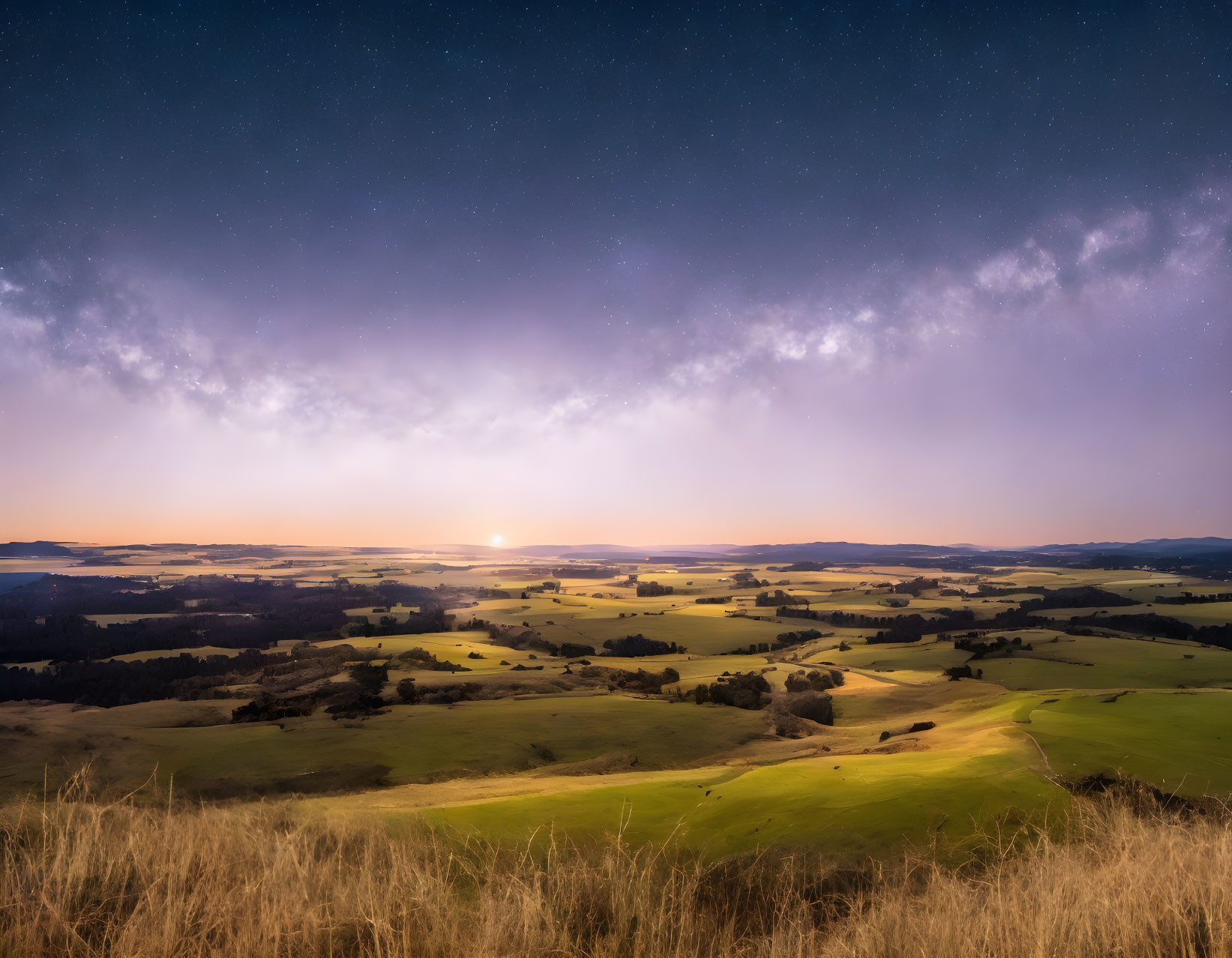 Twilight landscape with starry sky, rolling hills, glowing sunset, and lush green fields