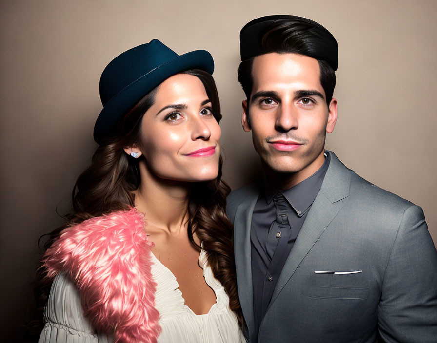 Fashionable Couple in Gray Suit and Cream Dress with Pink Feather Boa