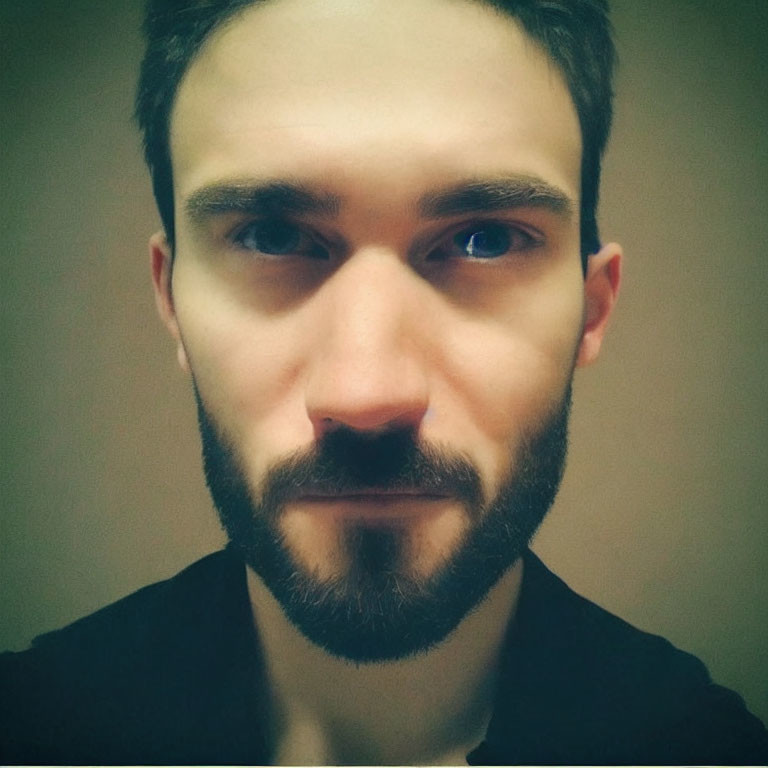 Man with Beard and Mustache in Serious Expression, Dark Eyes, Black Shirt