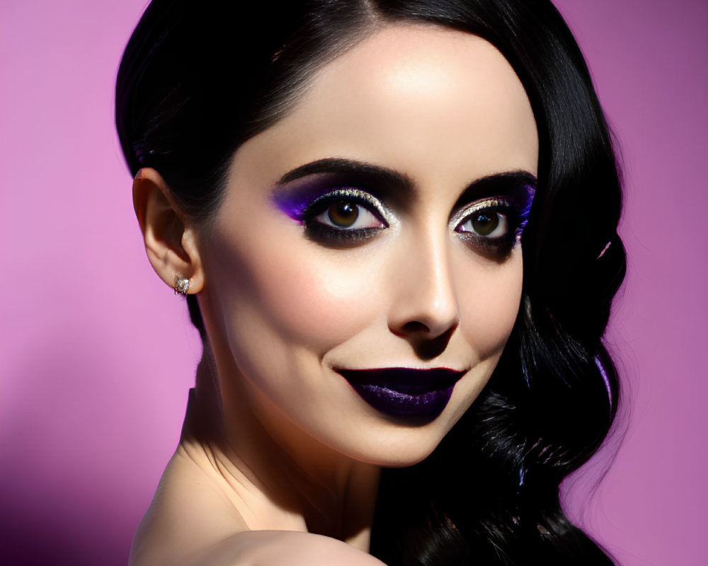 Dark-haired woman with bold purple makeup on purple background