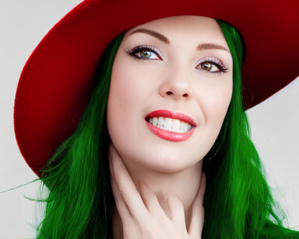 Smiling woman with green hair and red hat in green sweater