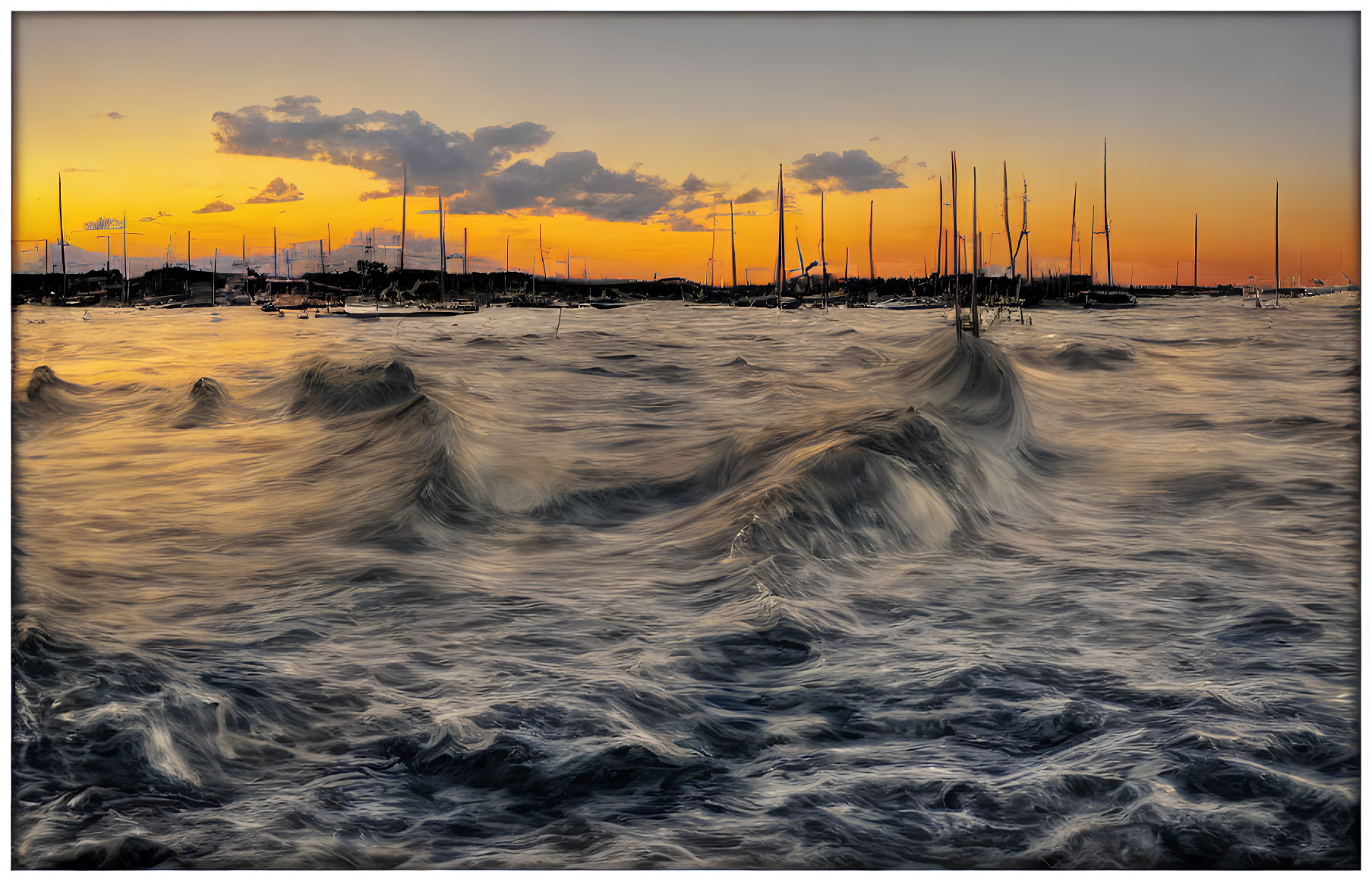 Colorful sunset over choppy sea with waves, sailboats, and dramatic sky