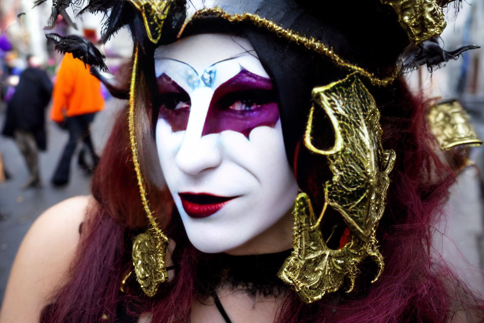 Jester-like makeup and costume with white, purple, and gold accents