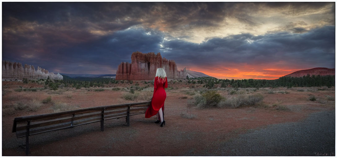 Person in red dress admiring sandstone landscape at sunset