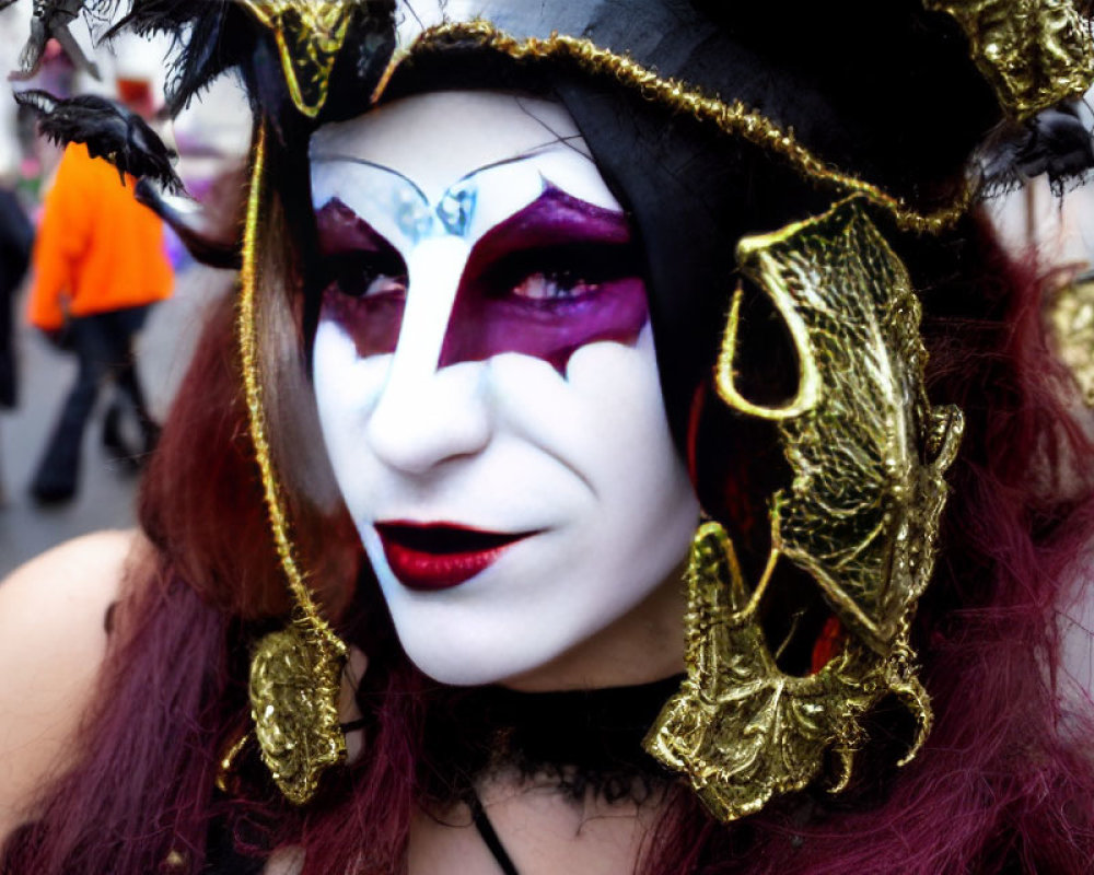 Jester-like makeup and costume with white, purple, and gold accents