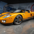 Yellow Sports Car with Black Racing Stripes and Decals in Studio Setting