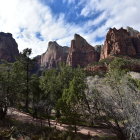 Colorful desert landscape with red rock formations and greenery