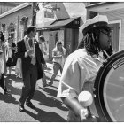 Monochrome image of people in zombie makeup on street with reflection