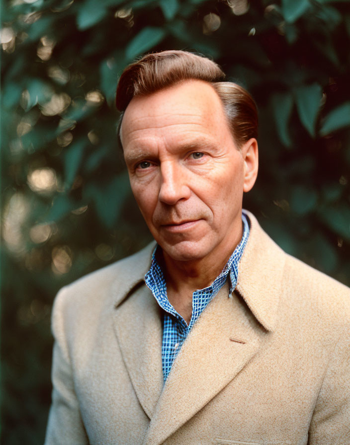 Man in Tan Coat with Slicked-Back Hair in Blue Checkered Shirt