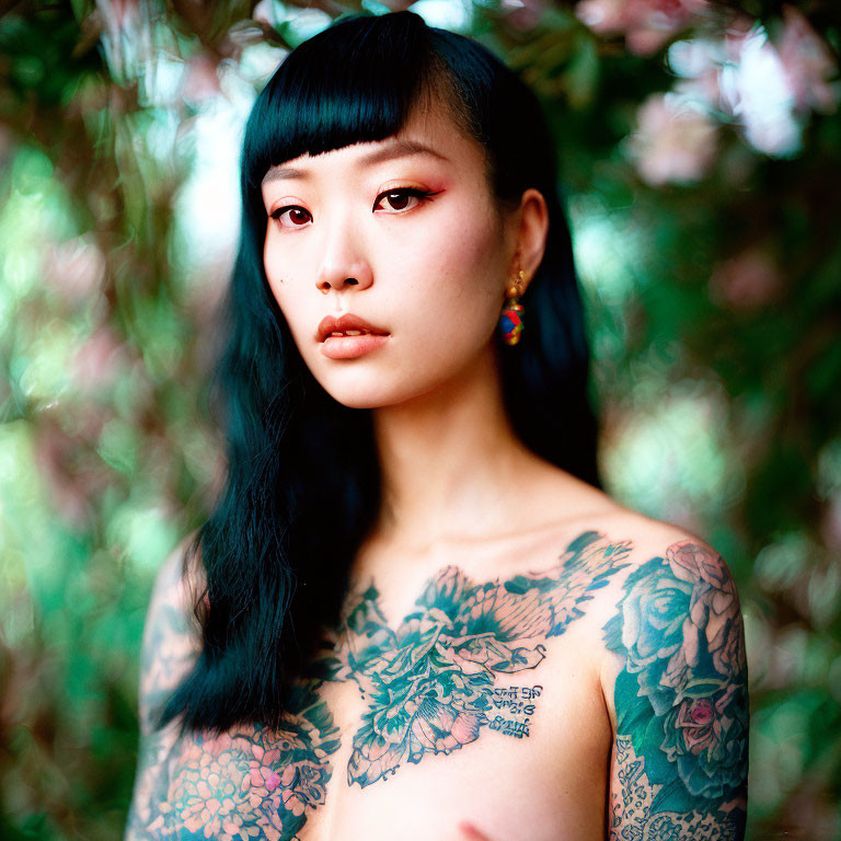 Woman with Floral Tattoo on Chest and Shoulder in Green Foliage