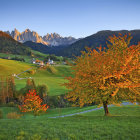 Vibrant orange and green landscape with distant town and spire