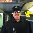 Bearded man in blue suit and top hat in vintage train carriage