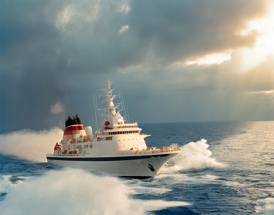 White ship with red funnel sailing on dramatic ocean waves