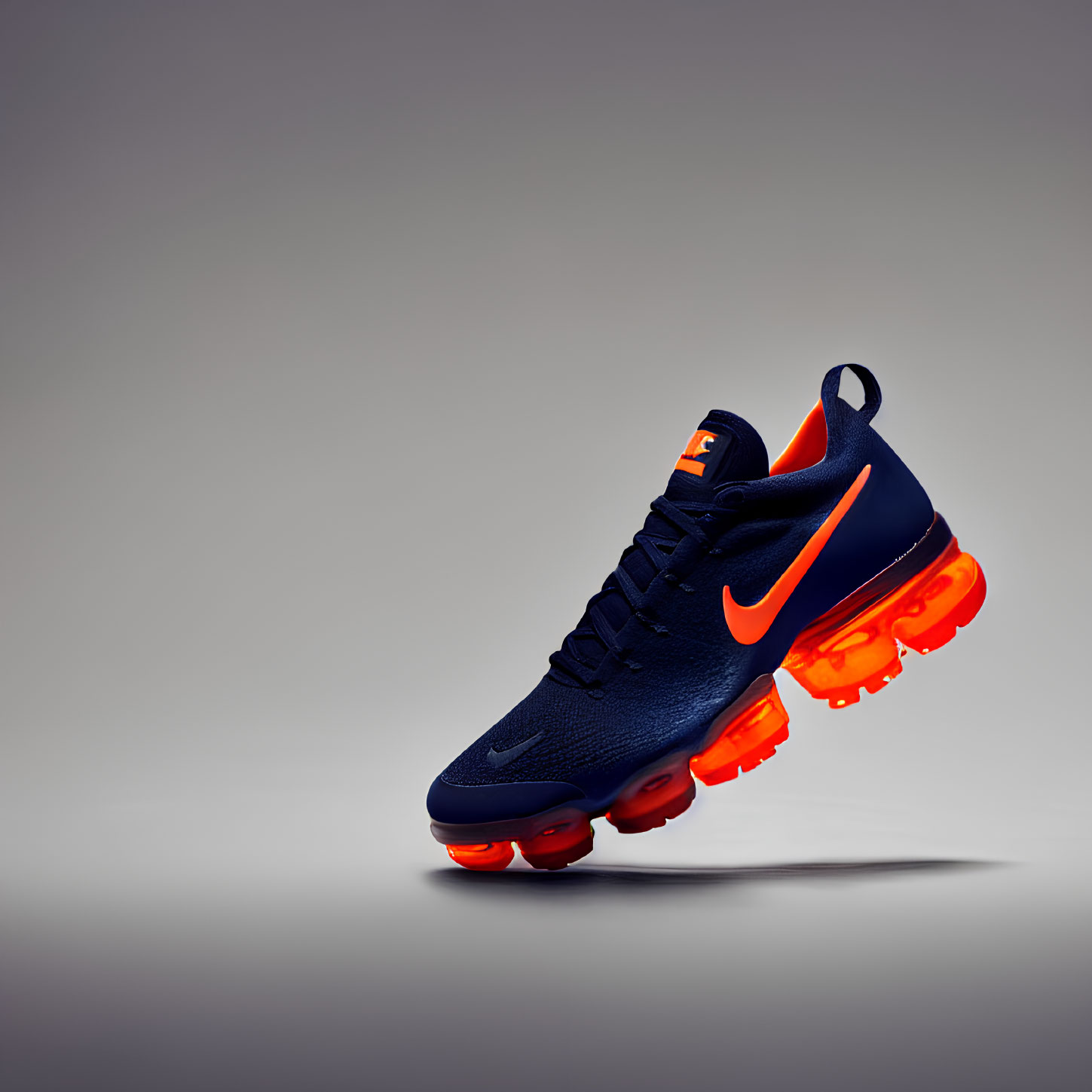 Dark Blue Nike Sneaker with Orange Accents on Grey Background