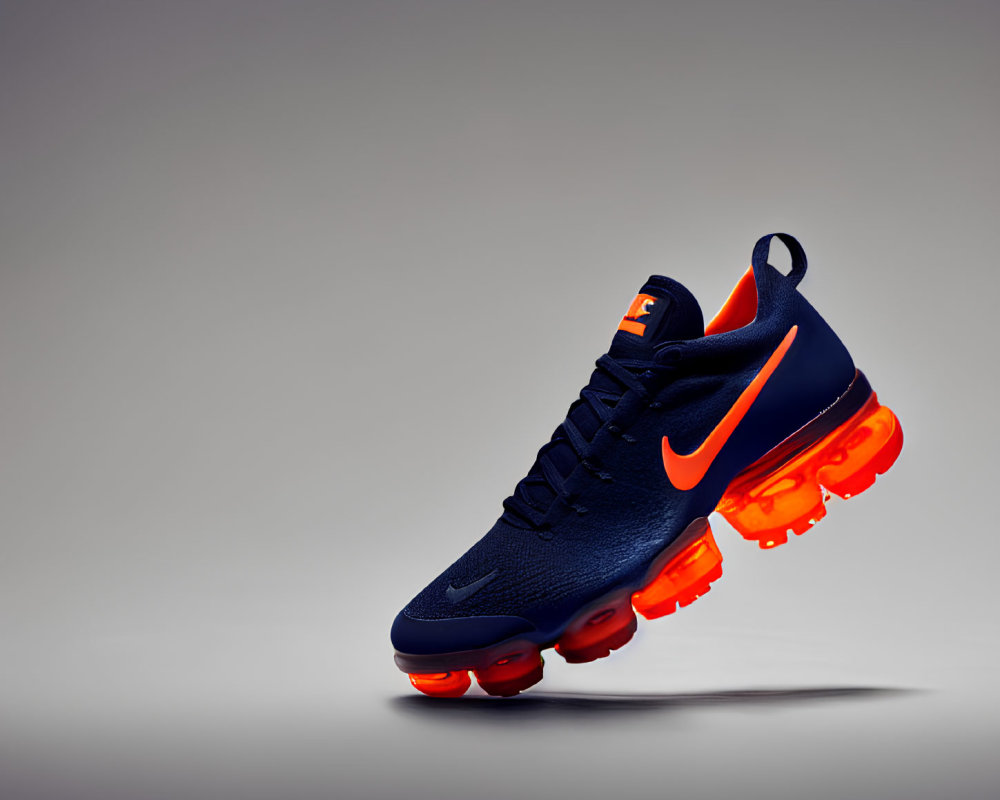 Dark Blue Nike Sneaker with Orange Accents on Grey Background