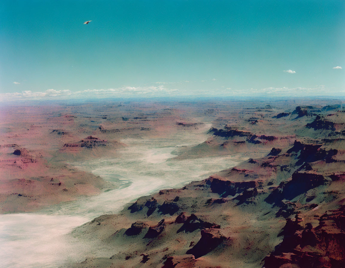 Desert landscape with undulating terrain and clear sky.