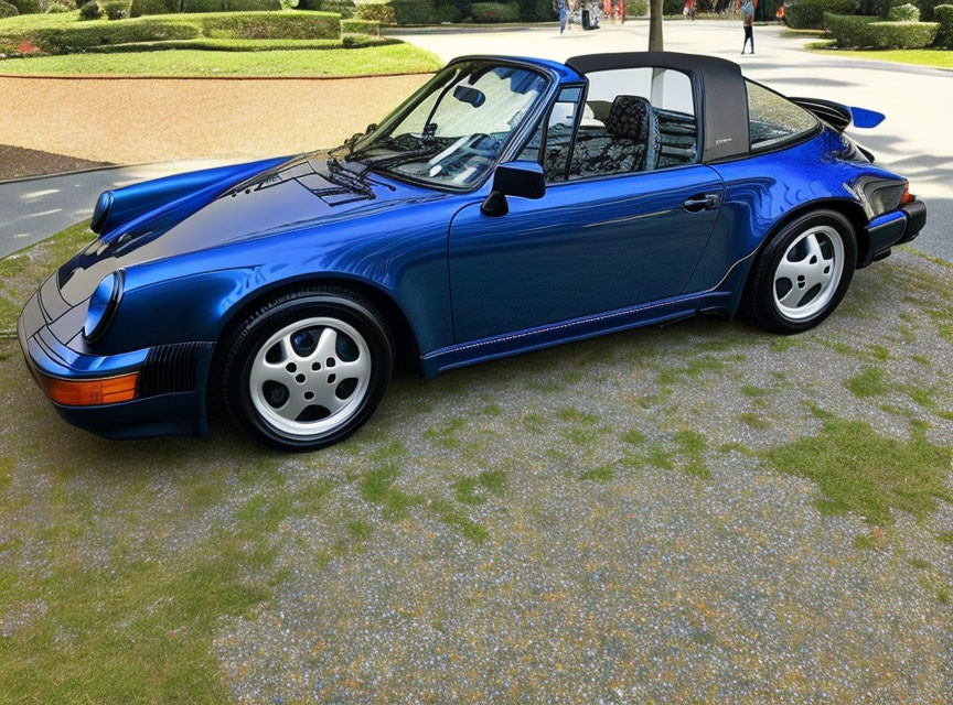 Blue Porsche 911 Convertible with Black Soft Top on Brick Driveway