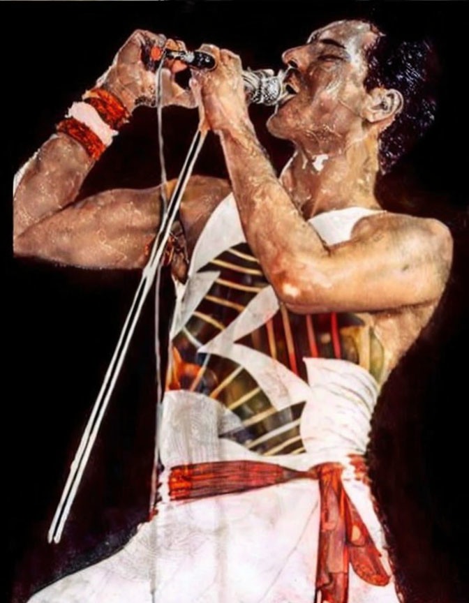 Energetic performer in white tank top and pants singing with red armband