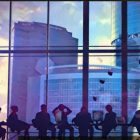 Airport Terminal Passengers View Aircraft at Colorful Sunset