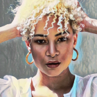 Stylized portrait of woman with curly blonde hair and hoop earrings