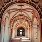 Vaulted corridor watercolor painting with arched ceilings and light casting shadows.