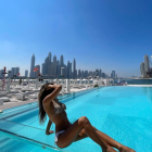 Animated woman in scuba goggles by pool with city skyline backdrop