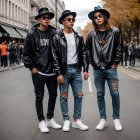 Stylish men in leather jackets and hats on city street with autumn trees