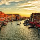 Historic Venetian architecture and Basilica domes at sunset along Grand Canal
