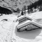 Monochrome snowy landscape with bridge-house and village