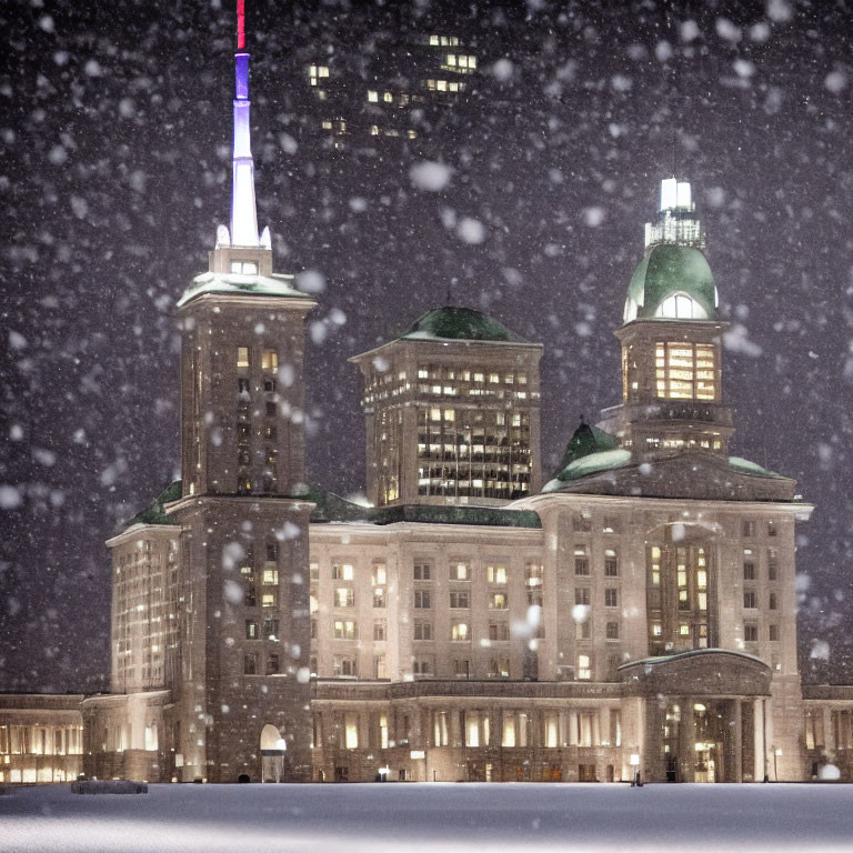 Historic building with illuminated windows in heavy snowfall