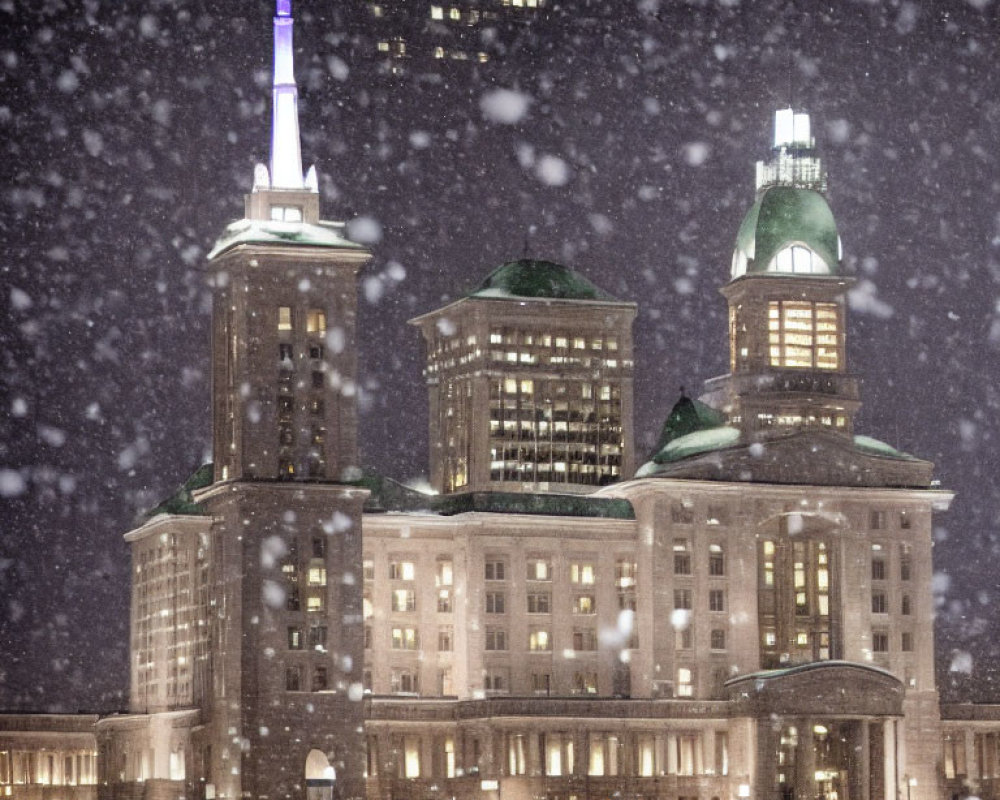 Historic building with illuminated windows in heavy snowfall