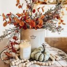 Colorful Pumpkins and Fall Foliage on Patterned Tablecloth