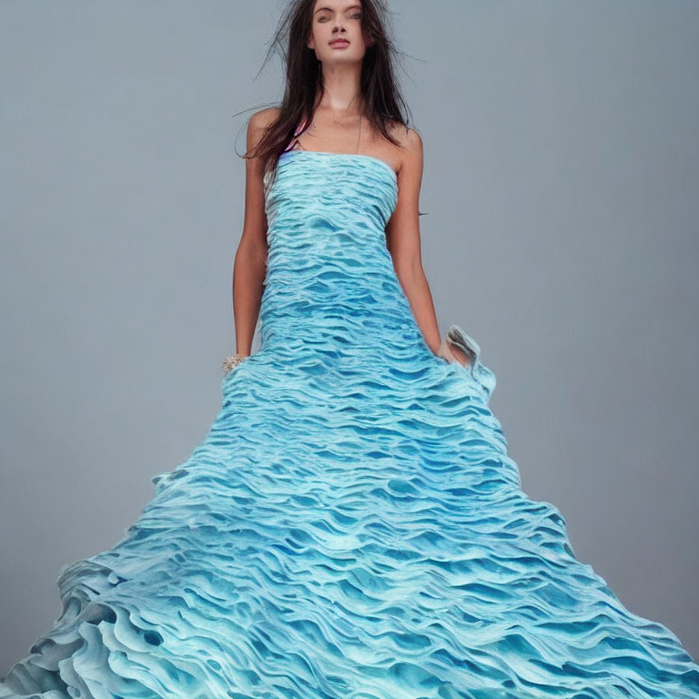 Woman in Strapless Turquoise Dress Against Plain Background