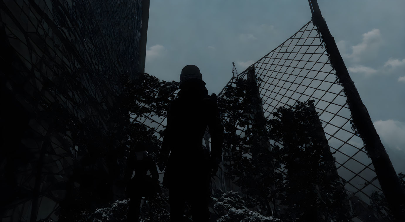 Person silhouette by ivy-covered fence in snowy urban scene at night.