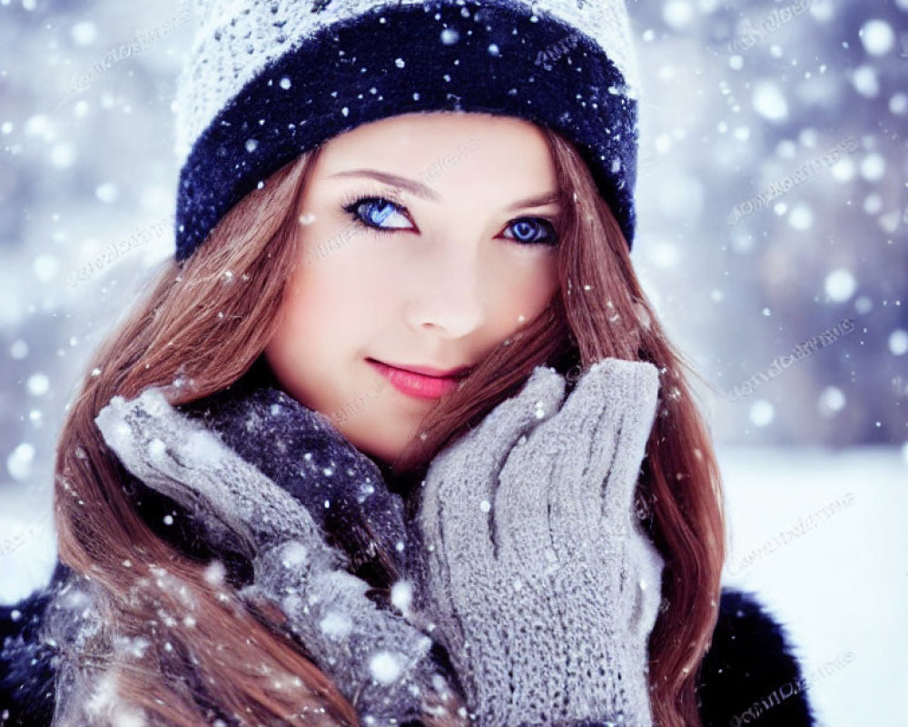 Blue-eyed woman in winter hat and gloves smiling in snowfall